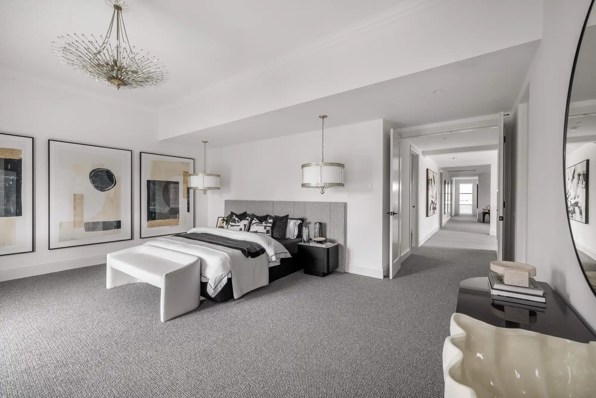 Master bedroom at the Durrant Masterpiece home. Featuring a chandler light in the room with two other luxury pendants.