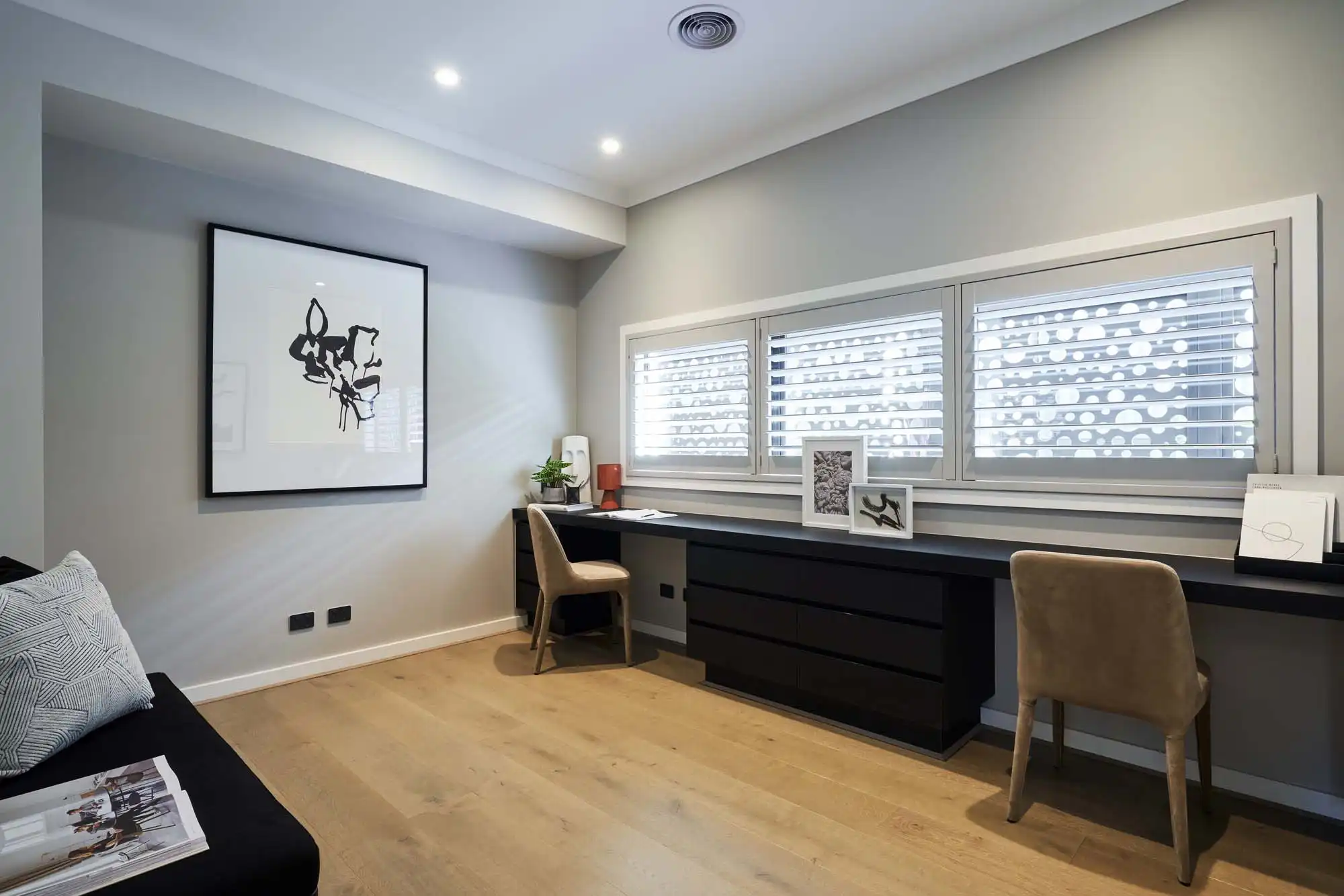 Dual study space for two with dark wooden cabinetry and light timber flooring to balance out the space at castlemaine 41