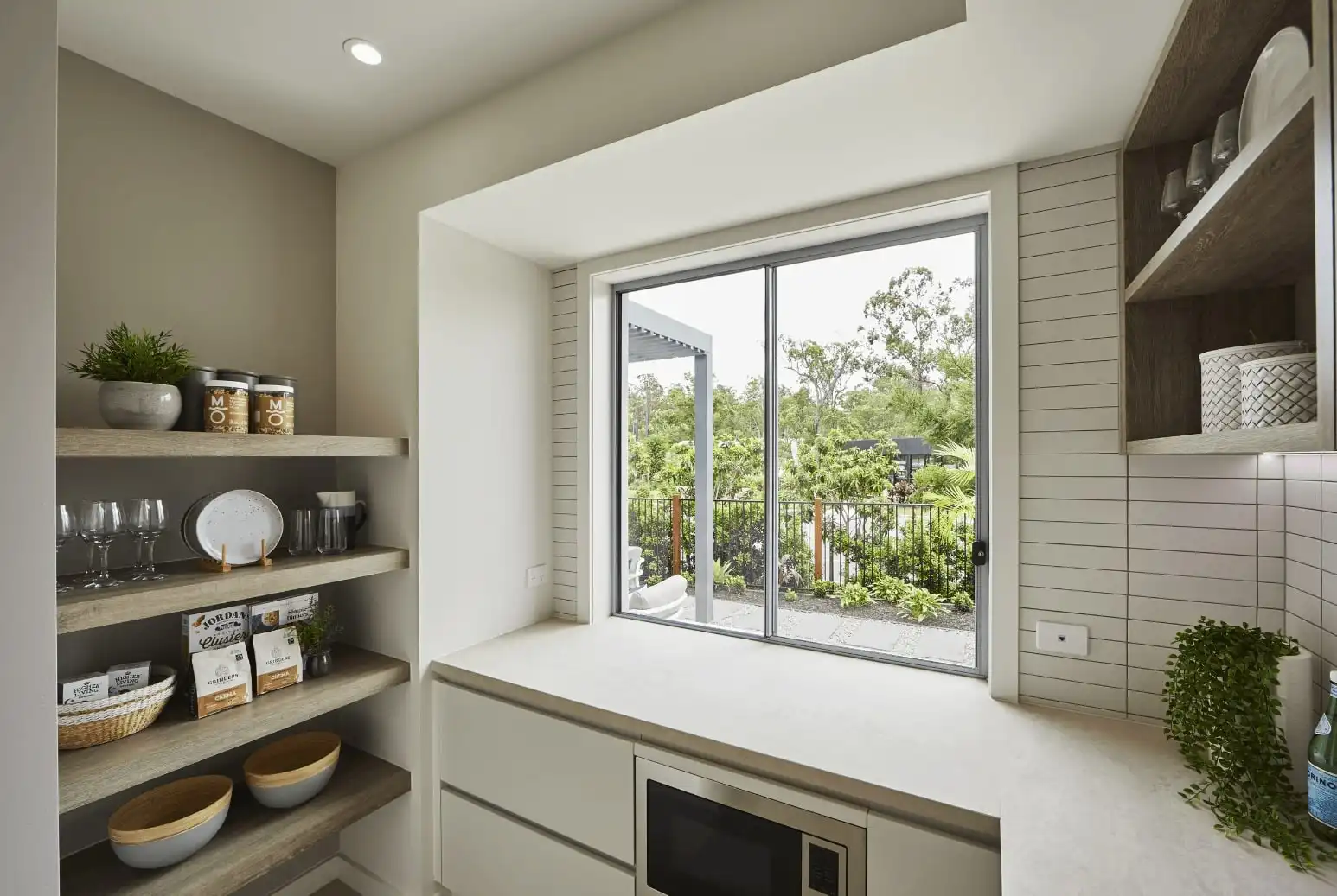 smooth vanity surface and neutral coloured palette with open sliding door windows in dalwood 25 butlers kitchen