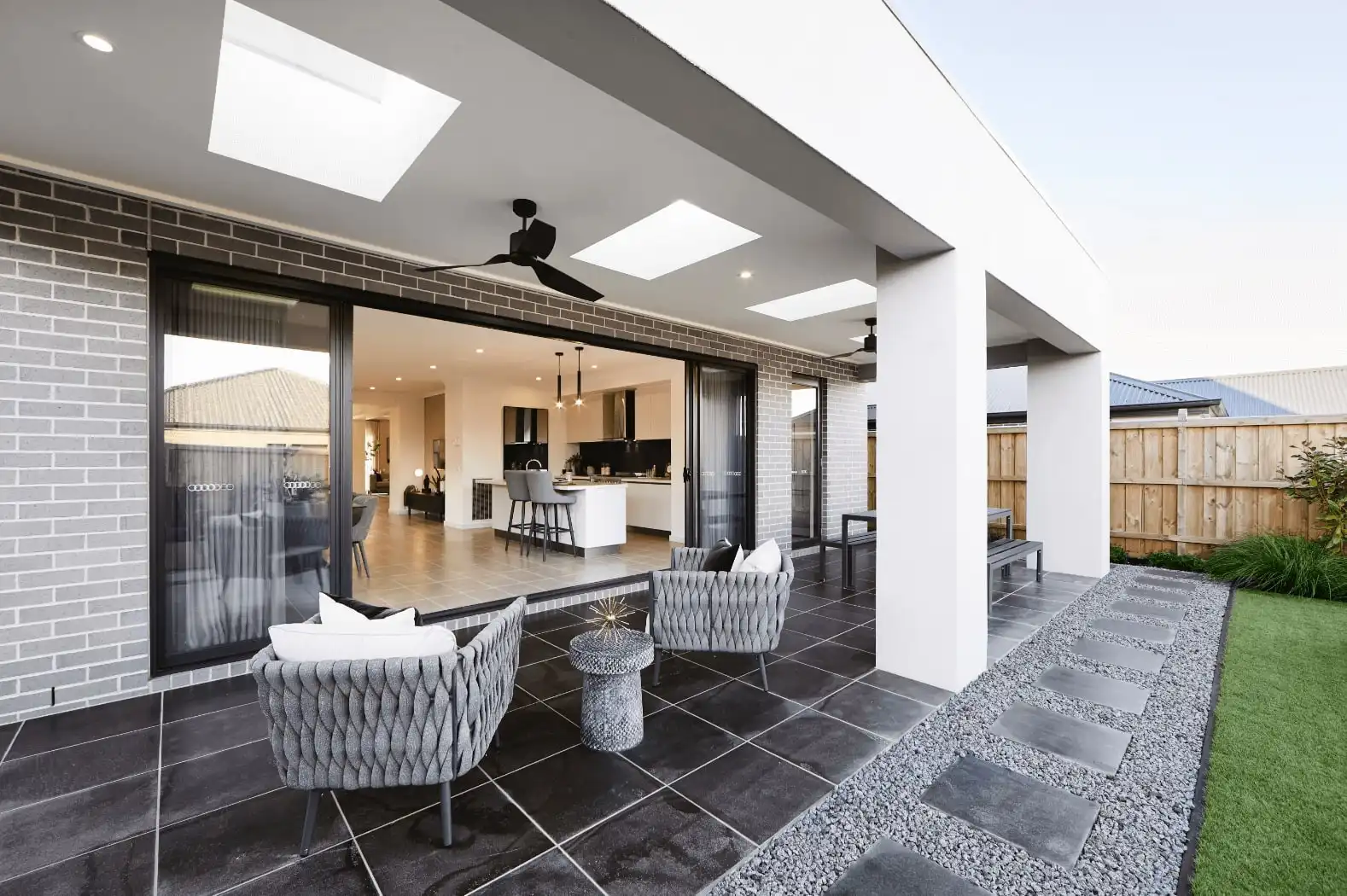 sheltered alfresco area with sliding doors and skylight features that include tile flooring inside and out at gisborne 34