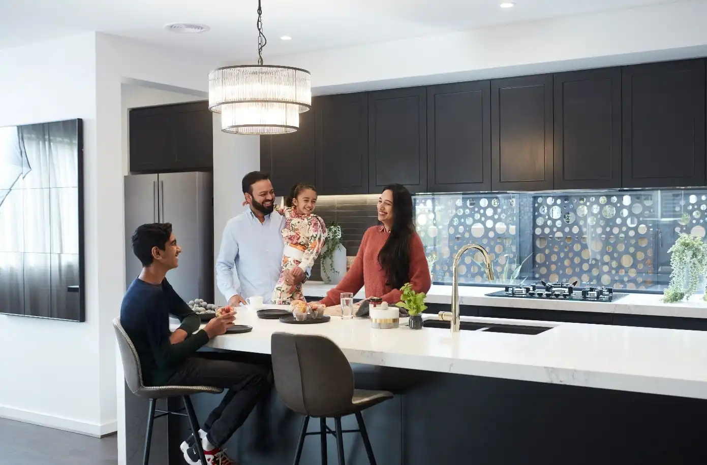 Customers in their new Simonds home with interiors fitted out featuring the gold chrome faucet