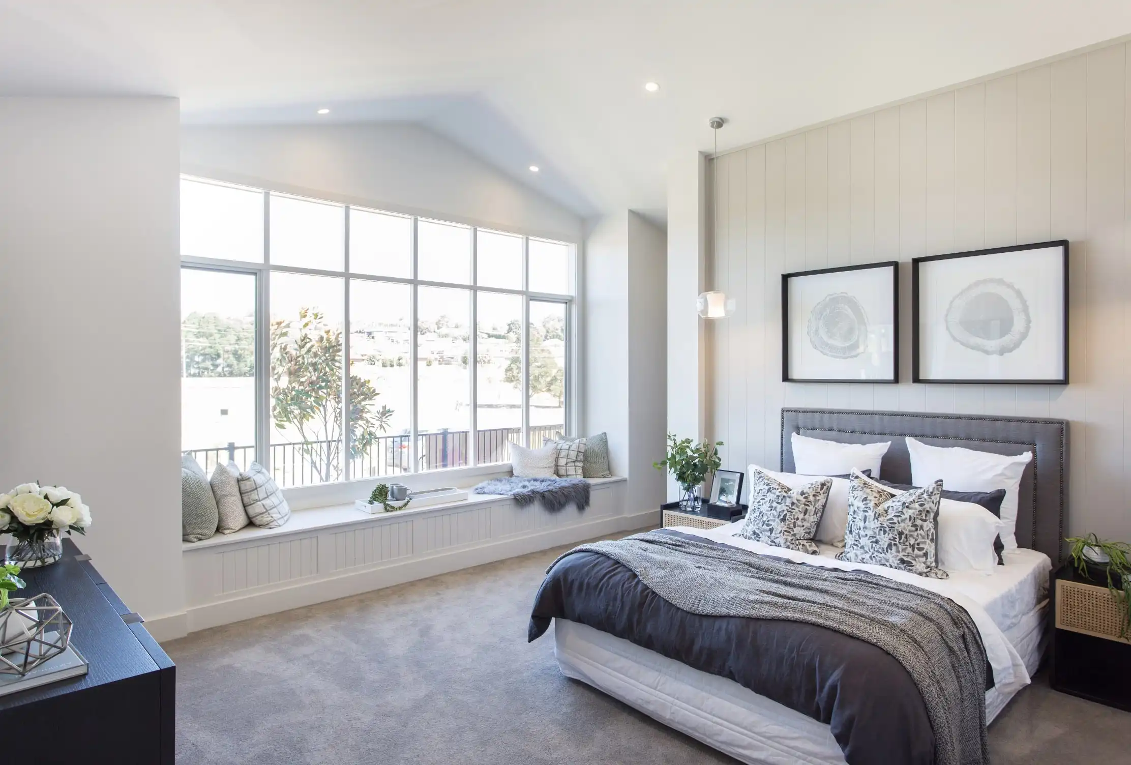 master bedroom with window nook and arched ceiling that flows in the natural light
