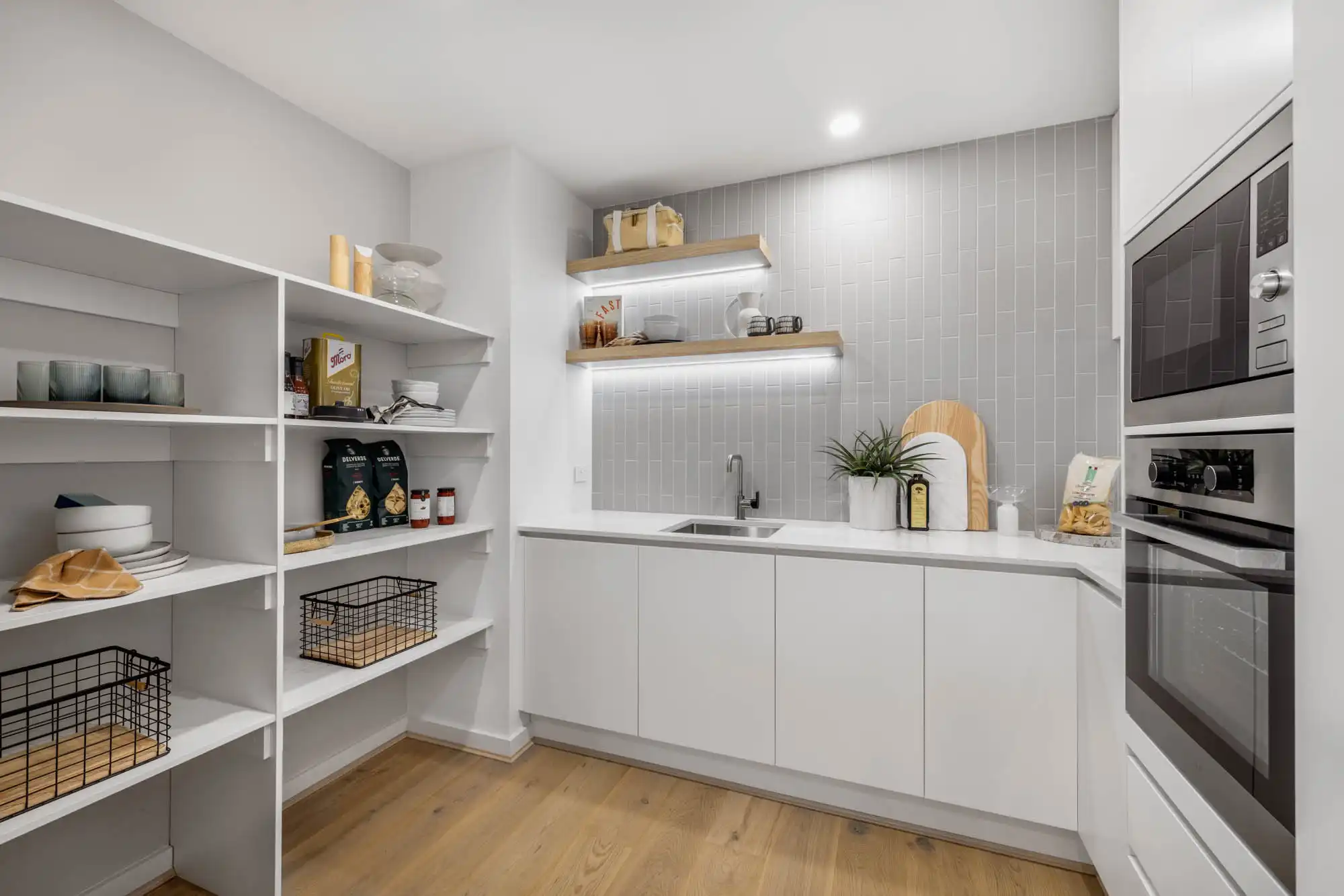 grey vertical stacked tiling in butler's pantry with timber shelving and flooring at hampstead 32 roseworthy