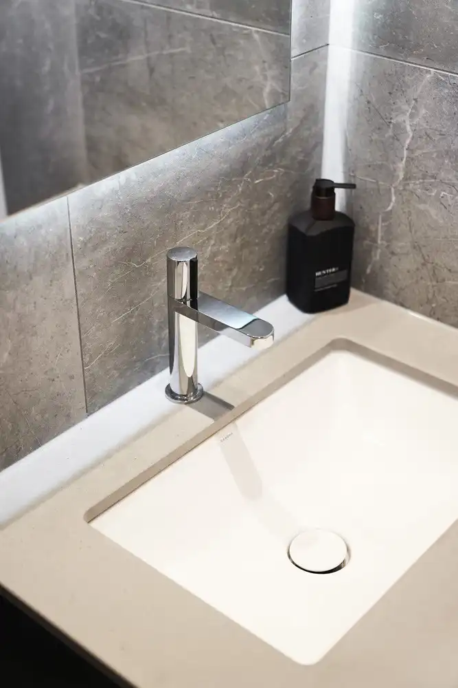 contemporary chrome facuet with lighting behind the mirror creates a ambient glow