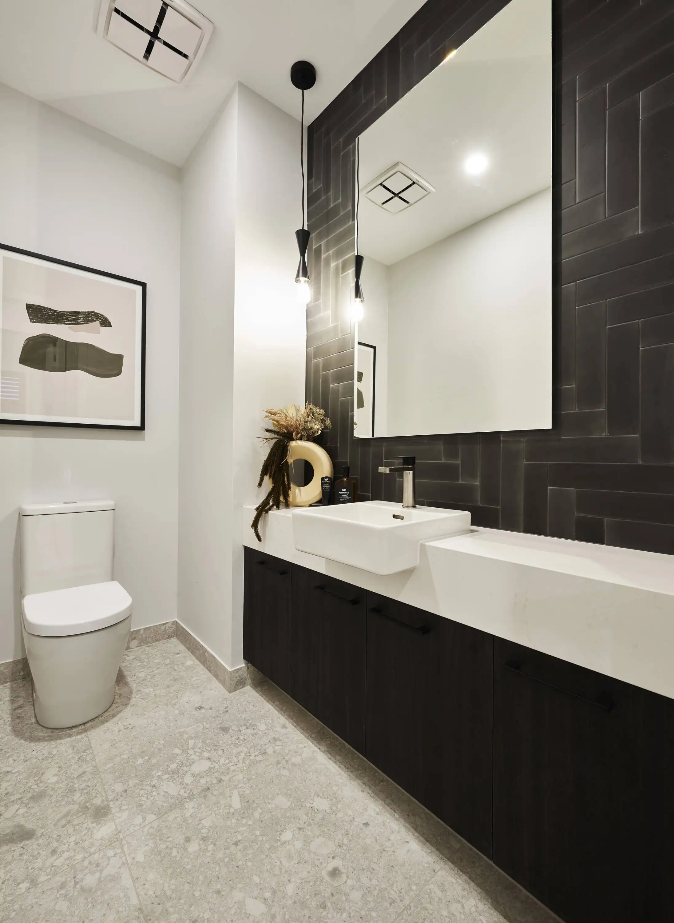 black patterned tiling in the powder room with timber cabinetry and stoned flooring at tamworth 32