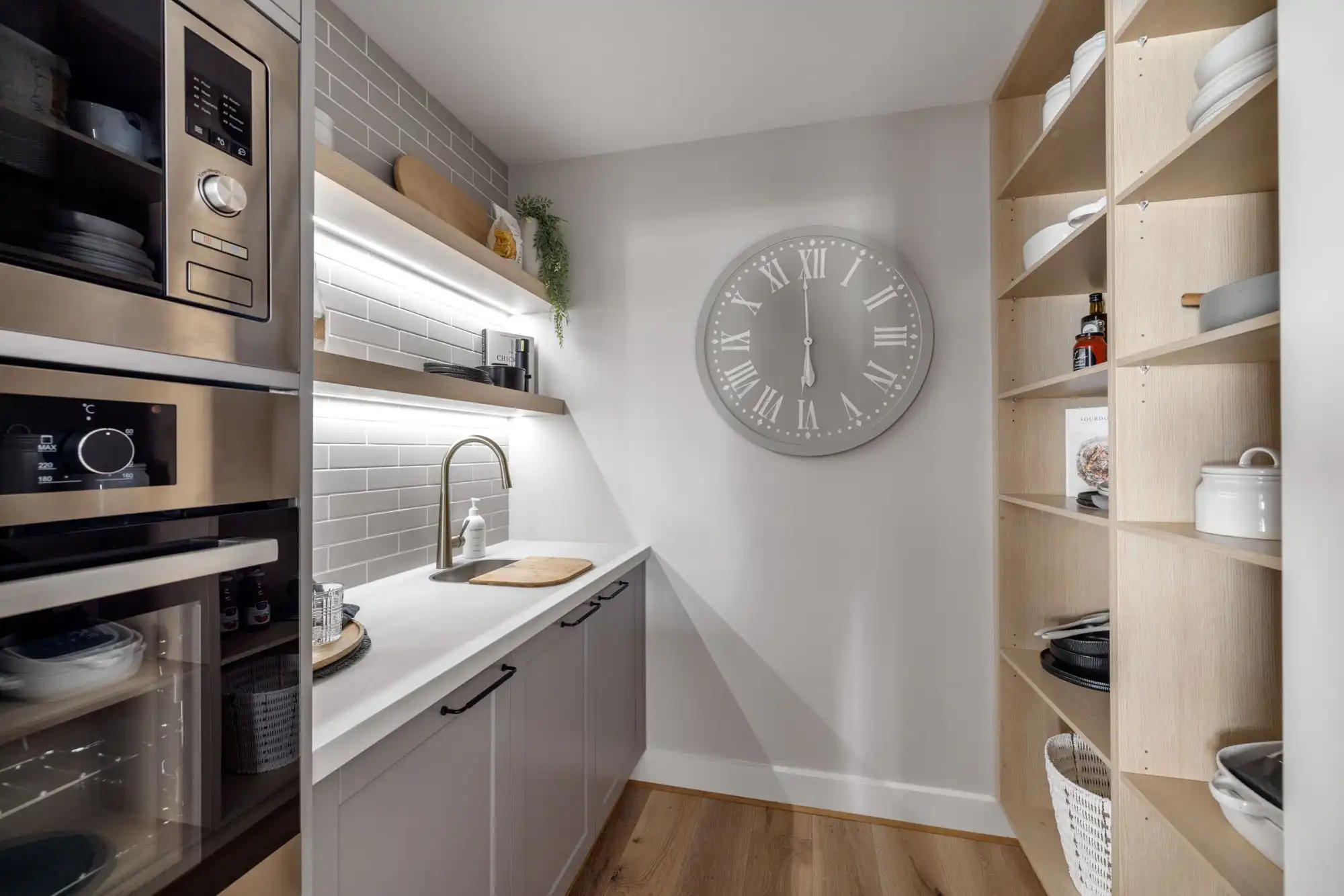butler's pantry with light grey staggered tiling chrome faucet and timber shelving