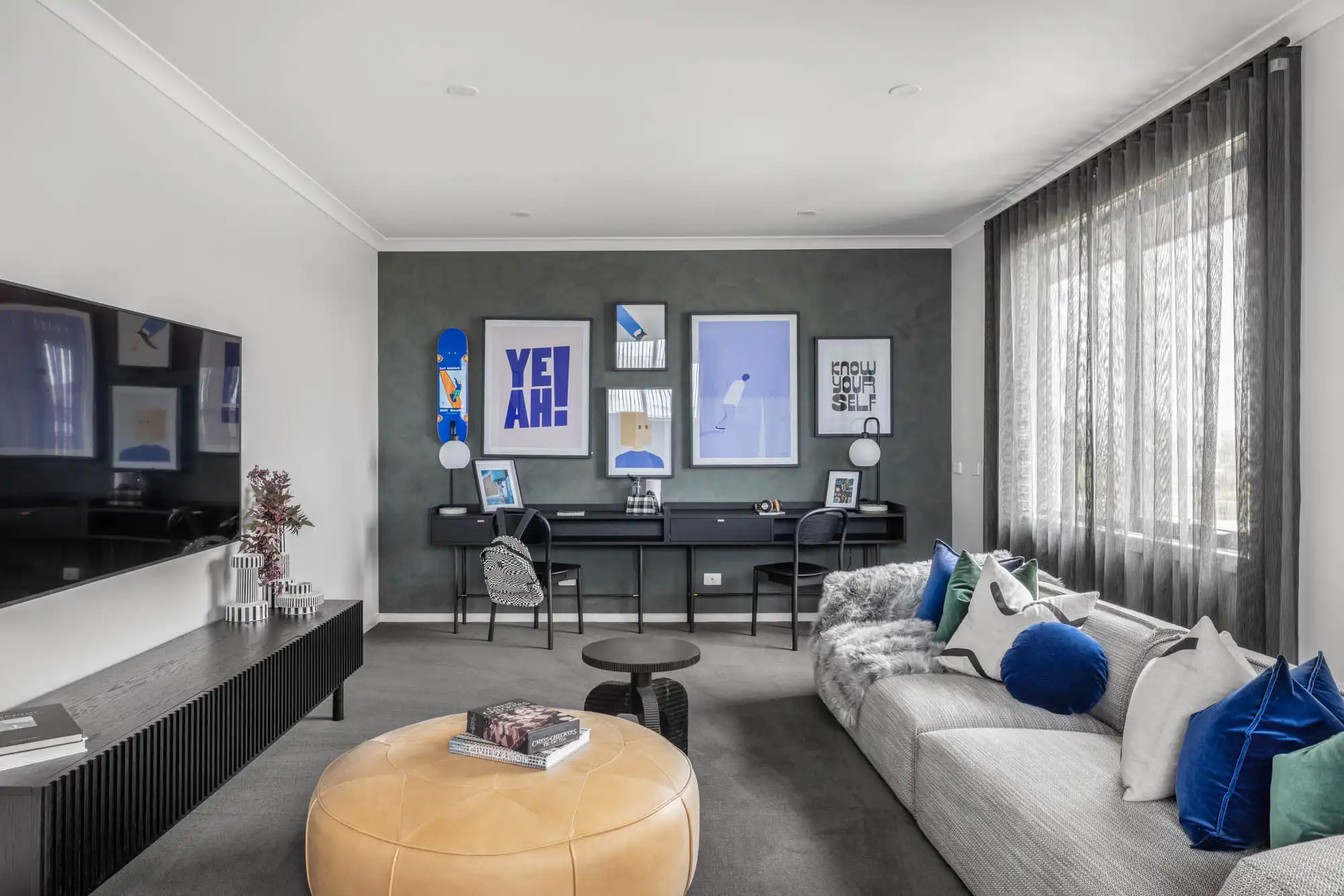 featured coloured wall with bold vibrant pillows at the family cinema home at lomandra 42