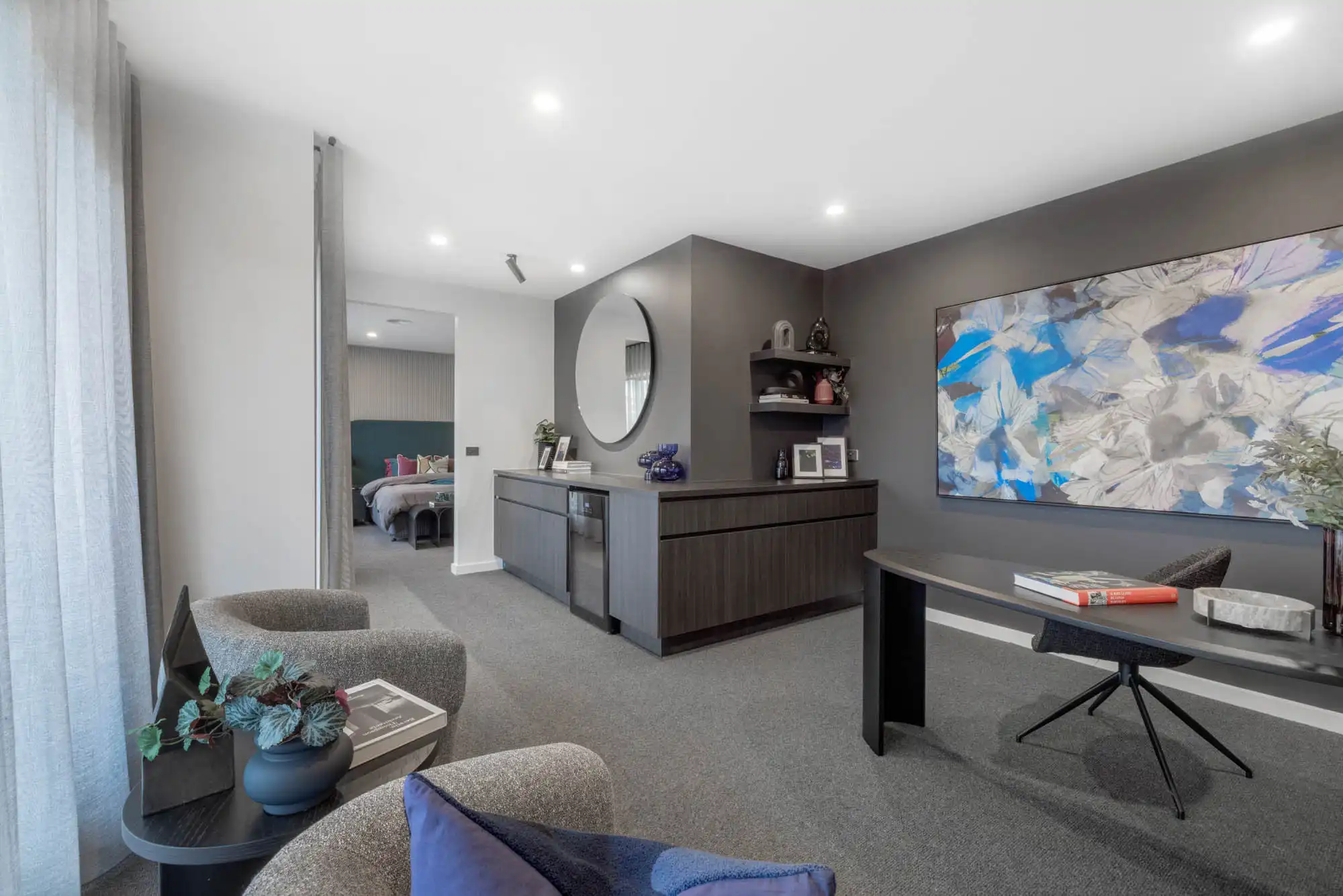 open plan master bedroom with sheer curtains throughout and a study wing to enhance your interiors