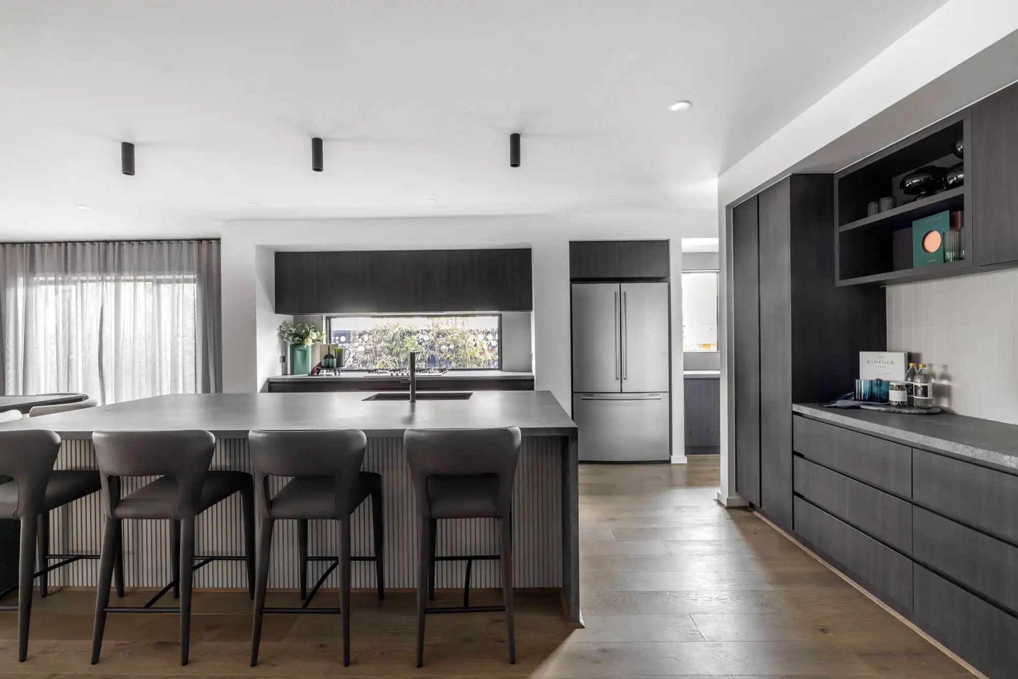 monochromatic timber dark tone kitchen with wood cladding built inside the island bench at silverton 45