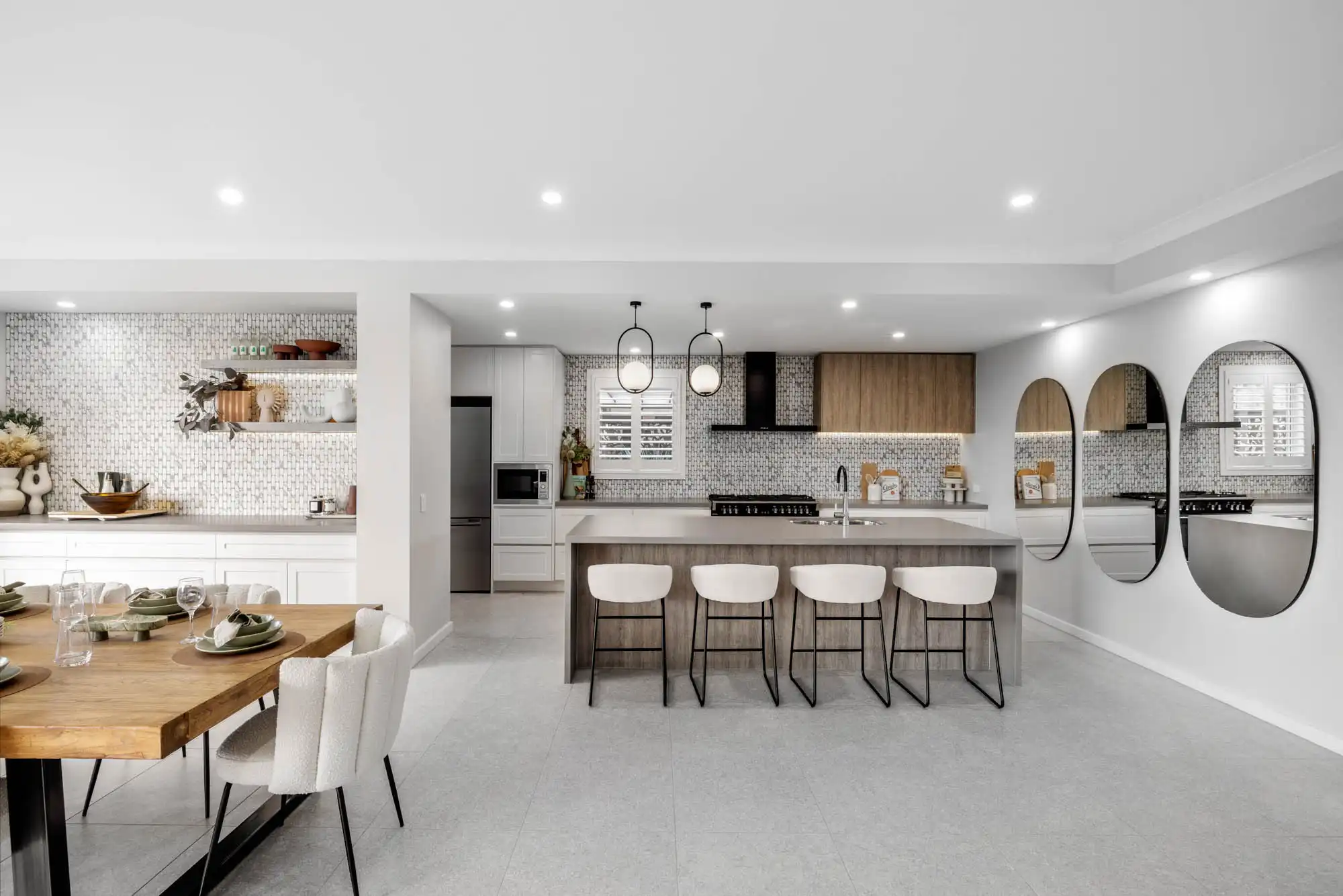 patterned splash back and crips white cabinetry with timber accents ties the space together aesthetically at tallowood 52