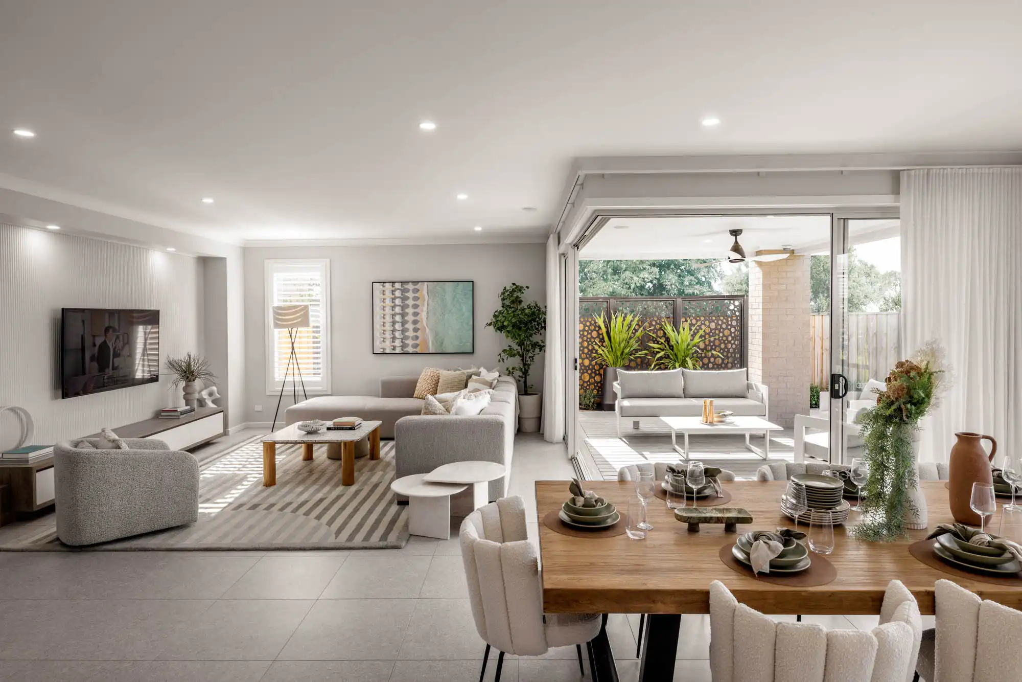 Interior photo of a living space with tiled floors that transitions to an outdoor area as a part of Simonds Tallowood 52 home design.