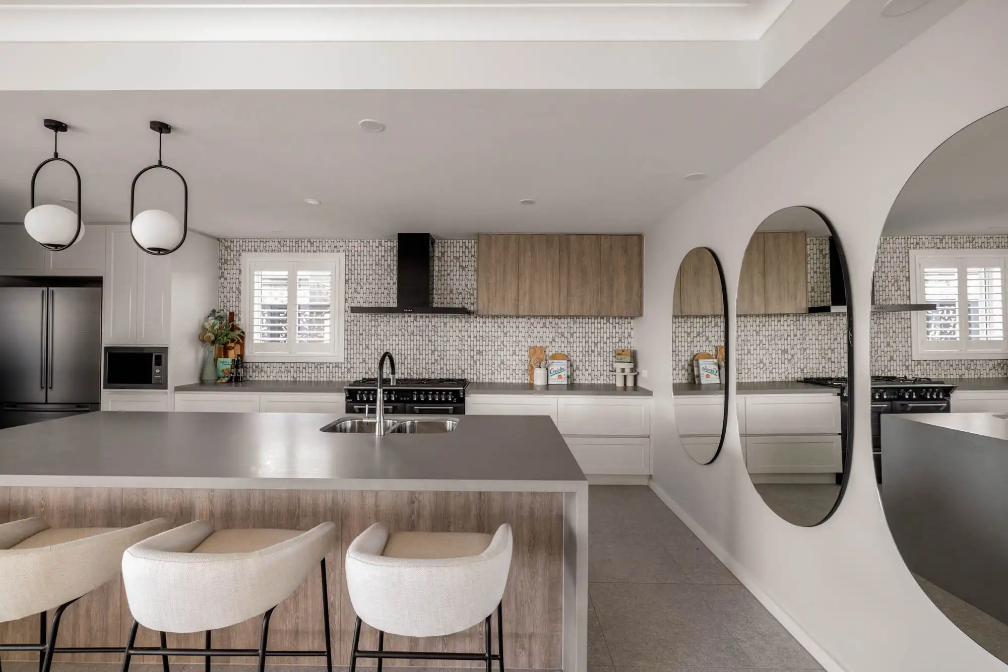 large mirrors open up the spaces and reflect a wider swath of the room