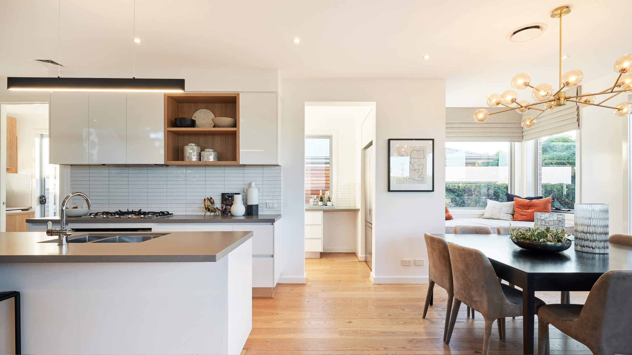 daybed featuring in a open kitchen space with butler's pantry and gold pendant lighting