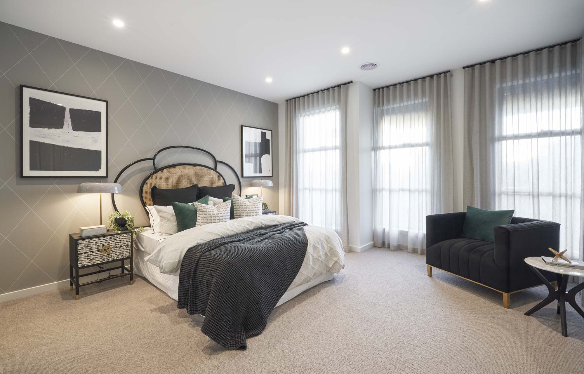Interior photo of a bedroom with a grey feature wall and the entire right side of the room being windows and blinds as part of the Simonds Tallowood 52 home design